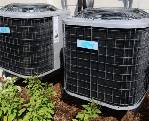 Two air conditioner condenser units.