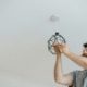 Bearded man changing a light bulb
