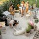 A group of friends laughing and having a good time in a backyard with no mosquitoes, enjoying the warm summer evening without interruption