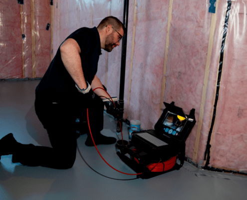 A home inspector performing a sewer inspection