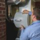 A technician servicing a central air humidifier.
