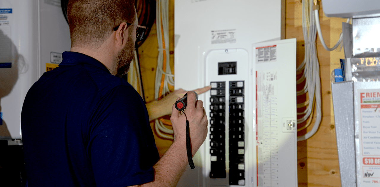 Man wearing a blue-collared shirt conducting a house inspection