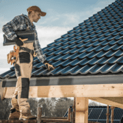 Worker inspecting a tiled roof.