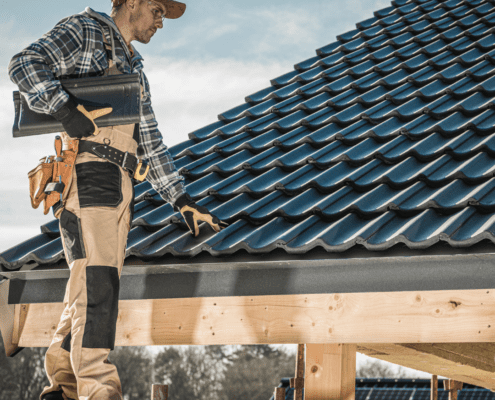 Worker inspecting a tiled roof.