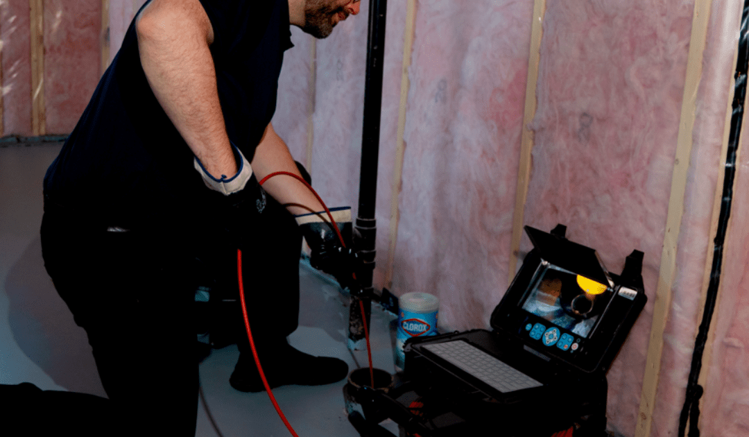 Inspector using a camera to check a sewer pipe.