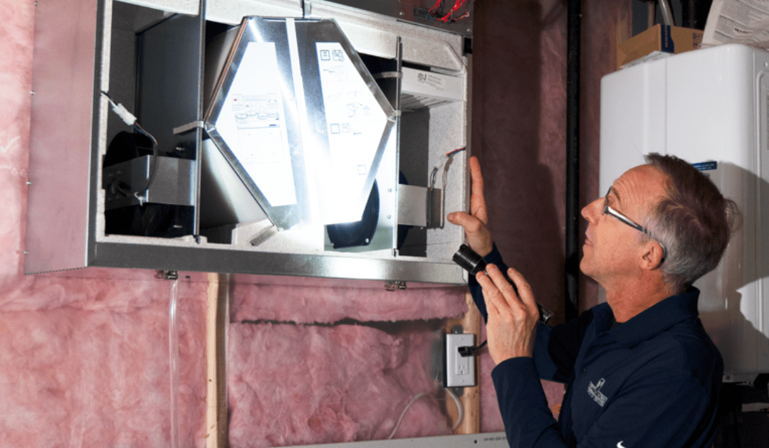 Technician inspecting a home ventilation system.
