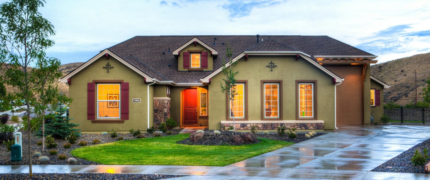 A landscaped yard with visible sloping to ensure water drainage away from the home.