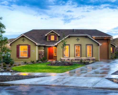 A landscaped yard with visible sloping to ensure water drainage away from the home.
