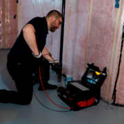 A home inspector performing a sewer scope inspection