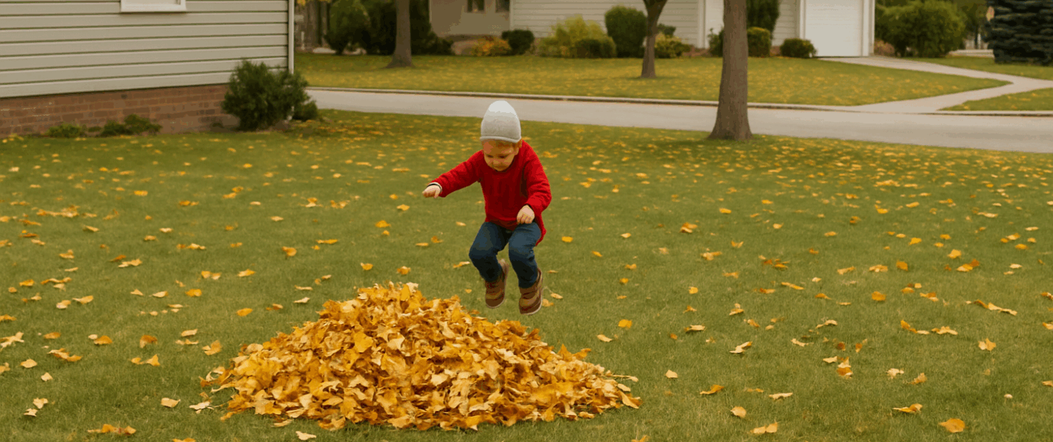 Fall garden cleanup – raking leaves into piles on a suburban lawn.